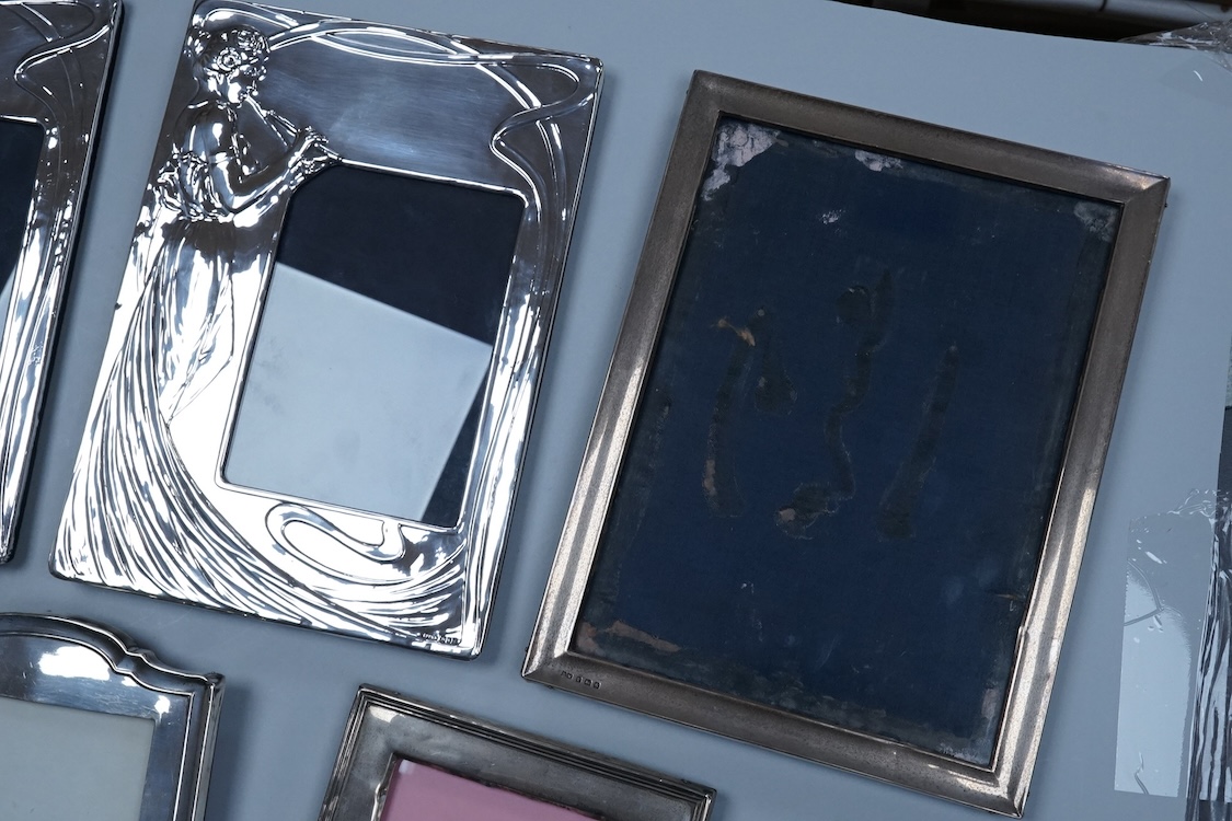 Three assorted George V silver mounted photograph frames, largest 23.9cm by 18.2cm, together with a pair of modern Art Nouveau style silver mounted photograph frames, PP & A, London, 1981.